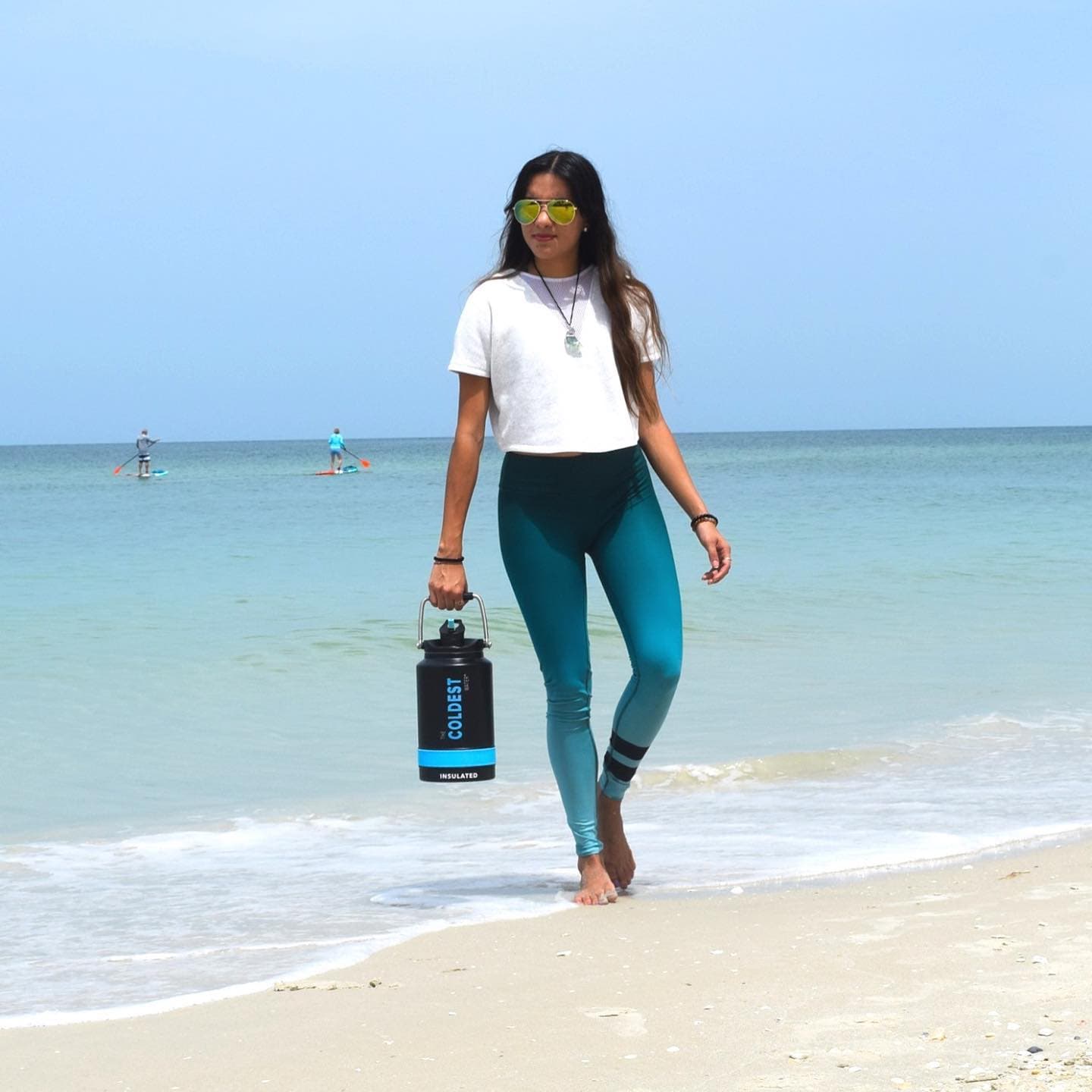 Standing on the beach with a Coldest bottle