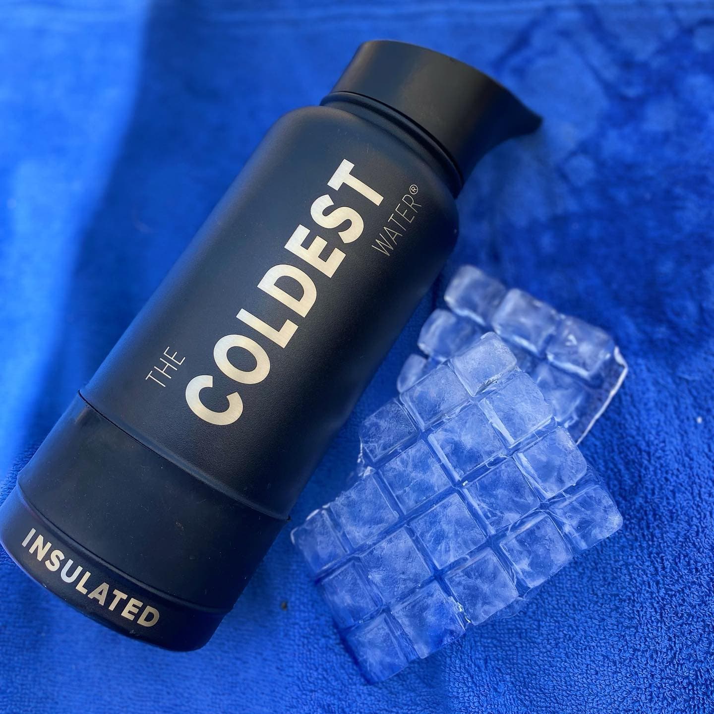 Coldest bottle surrounded by ice cubes