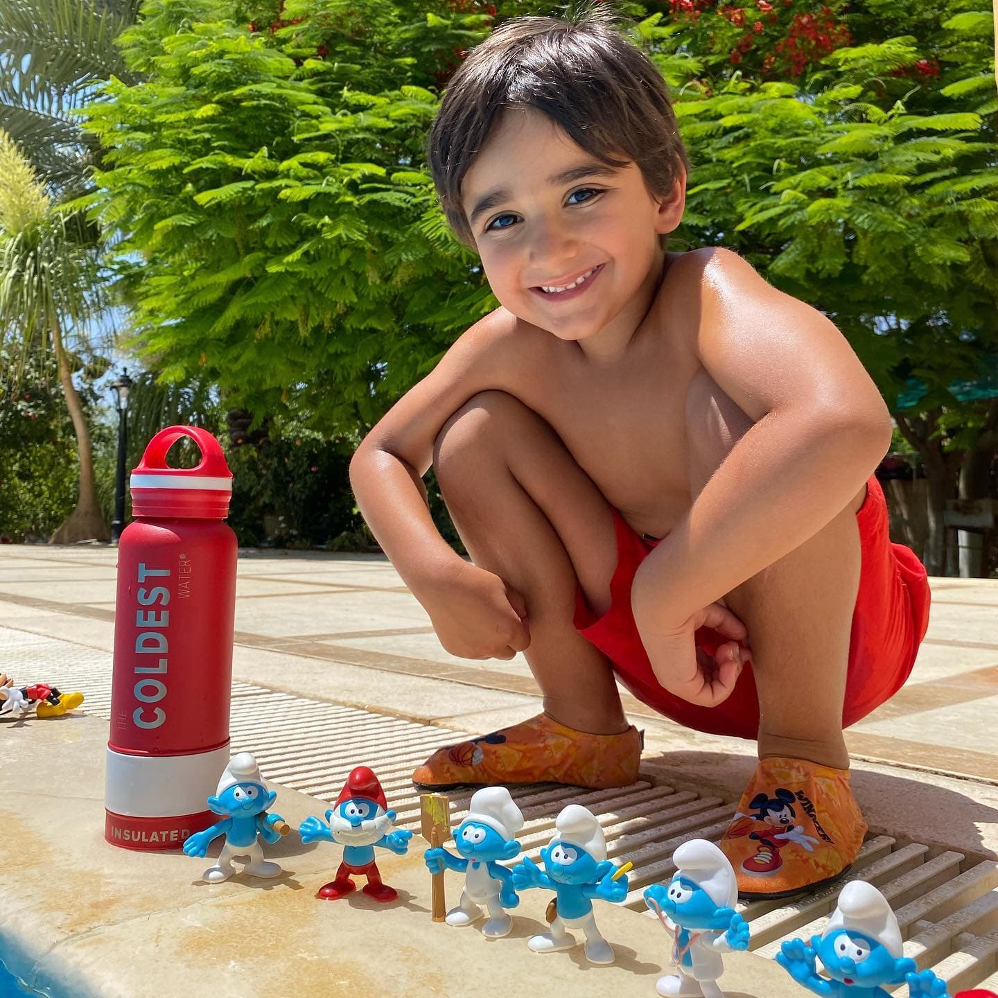 Pool toys next to a Coldest bottle